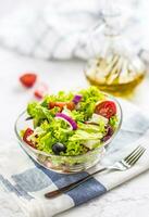 Spring vegetable salad with tomatoes onion cheese and olives. photo