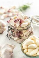 Garlic concept consisting of a jar full of lovely aromatic garlic cloves photo