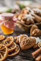 Gingerbread christmas cookies with jar of honey on kitchen table - Close-up photo