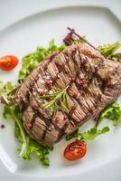 Close-up  juicy flank steak from vegetable salad. photo