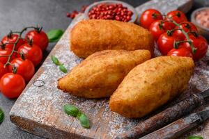 Delicious baked potato cutlet stuffed with chicken and vegetables, spices and salt photo