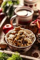 A bowl full of Christmas gingerbread along with hot punch photo