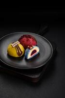 Delicious sweet colorful mochi desserts or ice cream with rice dough and toppings photo