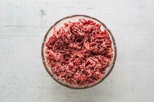 Minced beef pork or lamb meat in a glass bowl photo