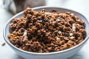 Jar of muesli with dark and milk cocolate pieces - closeup photo