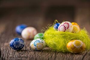 Easter. Hand made easter eggs on old wooden table. photo