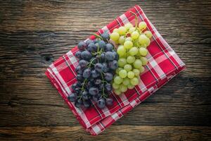 Grape. Bunch of multicolored grapes on rustic wooden table photo
