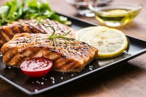 Grilled  salmon fillet with salad tomatoes and sesame photo