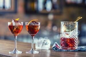 Manhattan cocktail drink decorated on bar counter in pub or restaurant. photo