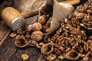 Walnut kernels whole walnuts in burlap sack and vintage bowl photo