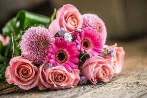 Close-up beautiful bouquet of flowers on wooden table. photo