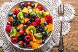 Fruit fresh mixed tropical fruit salad. Bowl of healthy fresh fruit salad - died and fitness concept. photo