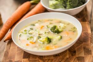 Vegetable soup from broccoli carrot onion and other ingredients. Healthy vegetarian food and meals photo