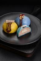 Delicious sweet colorful mochi desserts or ice cream with rice dough and toppings photo