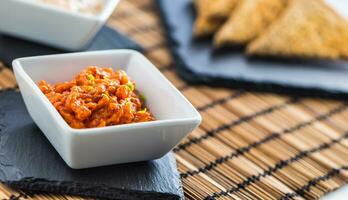 Tuna cereamy tartare with toast breads on slate board photo