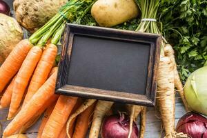 Top of view empty chalkboard on fresh vegetables photo