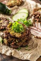 Crunchy zucchini pancakes with bacon parsley herbs and other ingredients photo