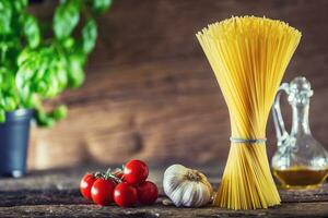 Spaghetti. Pasta spaghetti with basil garlic tomatoes cheese parmesan and olive oil photo