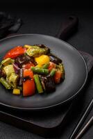 Delicious juicy fresh salad of baked eggplant, tomatoes, zucchini, onions photo