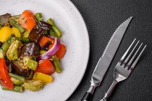 Delicious juicy fresh salad of baked eggplant, tomatoes, zucchini, onions photo