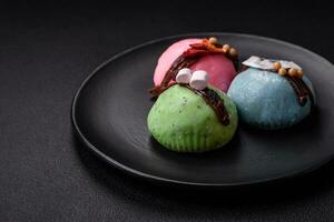 Delicious sweet colorful mochi desserts or ice cream with rice dough and toppings photo