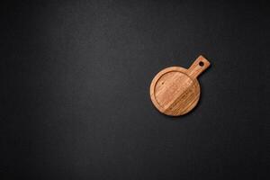 Empty round kitchen wooden cutting board in brown color photo