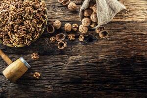 Walnut kernels whole walnuts in burlap sack and vintage bowl photo