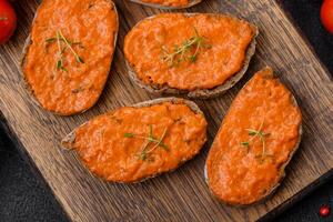 Delicious sandwich consisting of toast, red sauce with salt, spices and herbs photo