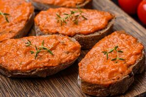 Delicious sandwich consisting of toast, red sauce with salt, spices and herbs photo