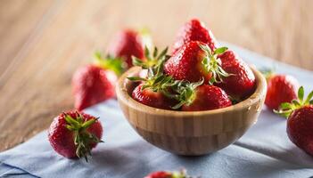 Juicy washed strawberries in wooden bowl on kitchen table photo