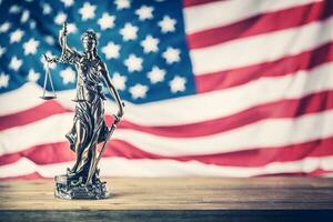 Lady Justice and American flag. Symbol of law and justice with USA Flag photo