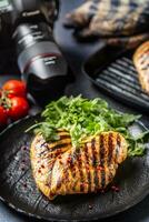 Chicken breast grilled with spices peper salt tomatoes and arugula photo