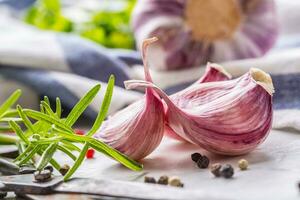 Garlic Cloves and Bulbs with rosemary salt and pepper. photo