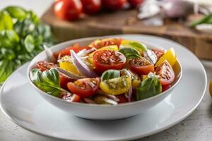 Tomato salad with red onion and olive oil is served in white bowl photo