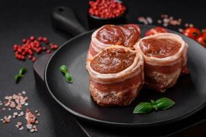 Delicious raw fresh pork or chicken meat rolls wrapped in bacon photo