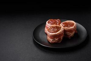 Delicious raw fresh pork or chicken meat rolls wrapped in bacon photo