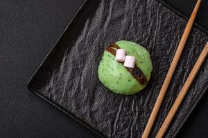 Delicious sweet colorful mochi desserts or ice cream with rice dough and toppings photo