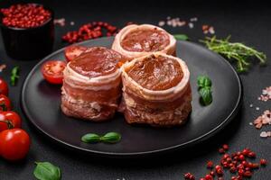 Delicious raw fresh pork or chicken meat rolls wrapped in bacon photo