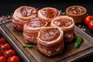 Delicious raw fresh pork or chicken meat rolls wrapped in bacon photo
