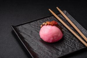 Delicious sweet colorful mochi desserts or ice cream with rice dough and toppings photo