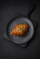 Delicious crispy croissant with salmon, lettuce, cheese and tomatoes photo