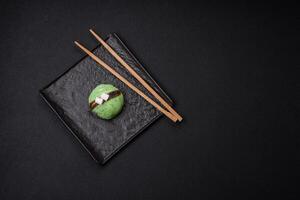 Delicious sweet colorful mochi desserts or ice cream with rice dough and toppings photo