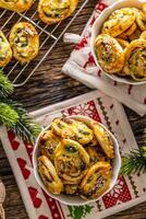 Christmas savory pastries, mini pizza cakes in a typical Christmas dish and festive decorations photo