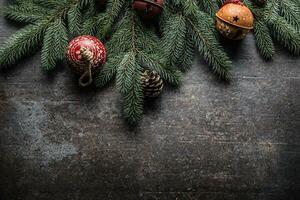 Top of view christmas decorations jingle bells fir tree pine cones on free concrete background photo