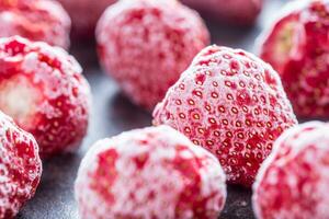 Close-up frozen strawberries covered by frost. photo