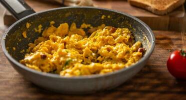 Freshly made scrambled eggs in a cooking pan photo