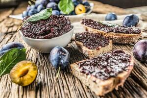 Breakfast from homemade plum jam bread and ripe plums. photo