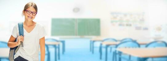 Portrait of modern happy teen school girl with bag backpack photo