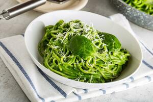 Spaghetti. Green spaghetti with spinach and parmesan. Italian and mediterranean cuisine photo