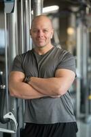 Smiling trainer coach in gym ready for training photo